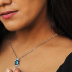 Model wearing a statement emerald-cut gemstone pendant necklace in silver, styled elegantly for both formal and evening occasions.