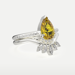 Angled view of a gemstone ring with a pear-cut center stone and sparkling accent stones, crafted in sterling silver with a premium finish.